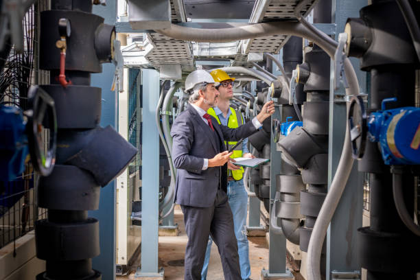 istock engineer under checking the industry cooling tower air conditioner is water cooling tower air chiller HVAC of large industrial building to control air system. 1422088919