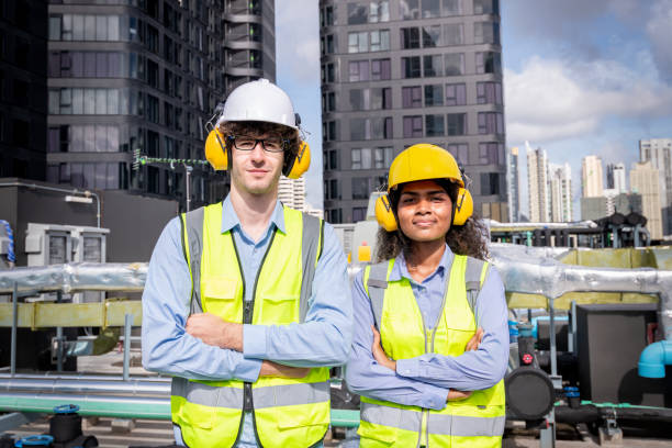 istock engineer under checking the industry cooling tower air conditioner is water cooling tower air chiller HVAC of large industrial building to control air system. 1422089594
