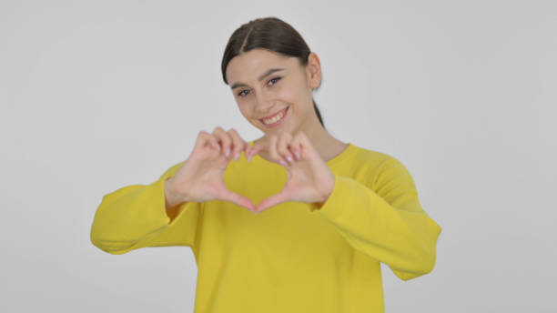 istock Heart Shape with Hands by Spanish Woman on White Background 1422096587
