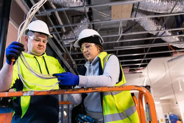 Photo of Real life female electrician and her coworker at work