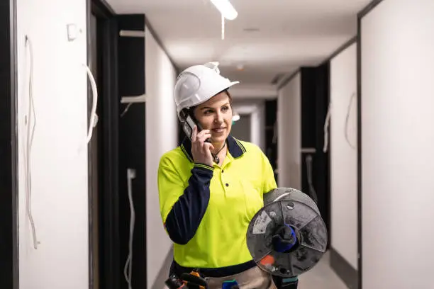 Photo of Real life female electrician on the phone at work