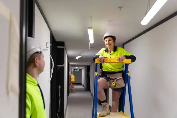 Photo of Real life female electrician and her coworker at work