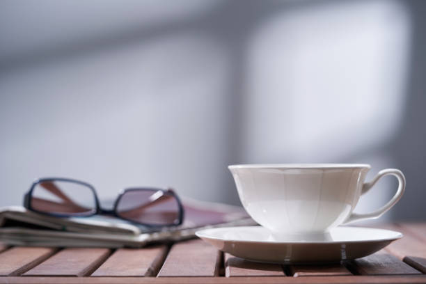 istock coffee cup newspaper and reading glasses 1422103115