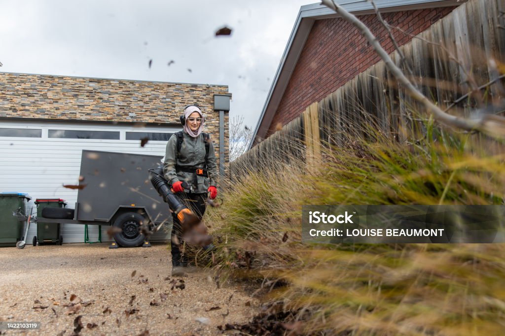 Real life female tradie working in her own landscaping business Lady tradie Tradesperson Stock Photo