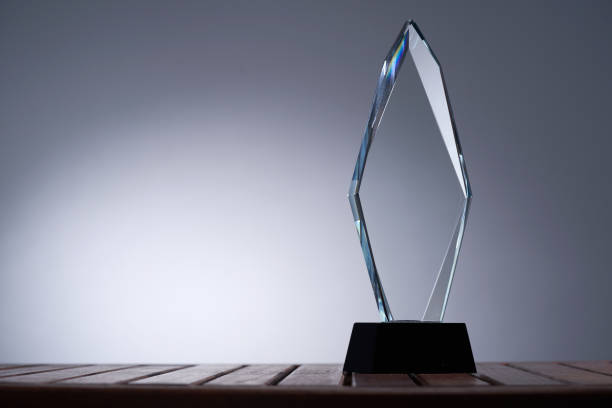 istock glass trophy on wood table against gray background 1422103419
