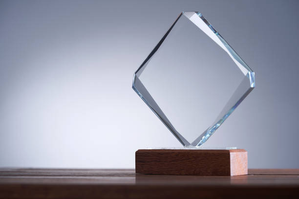 istock glass trophy on wood table against gray background 1422103455