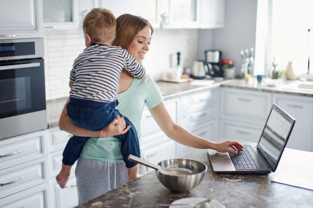 istock Mother holdin son and cooking 1422105595