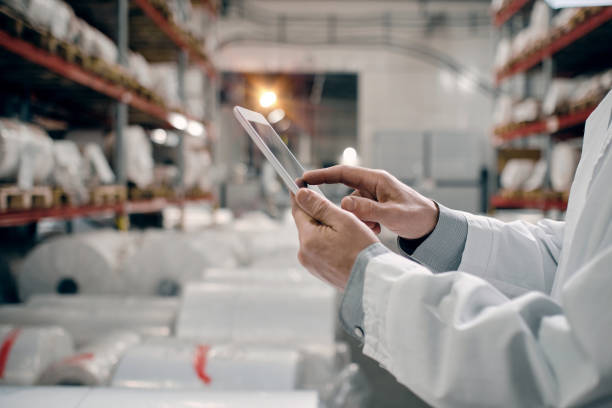 istock Hands touching tablet screen, working at factory 1422108126