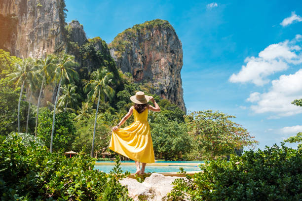 Woman tourist in yellow dress and hat traveling on Railay beach, Krabi, Thailand. vacation, travel, summer, Wanderlust and holiday concept Woman tourist in yellow dress and hat traveling on Railay beach, Krabi, Thailand. vacation, travel, summer, Wanderlust and holiday concept krabi province stock pictures, royalty-free photos & images