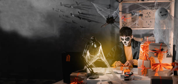 istock Successful small business owner, freelance makeup artist skeleton preparing package for delivery to customers, small and medium business entrepreneurs, halloween sale, promotions and discounts. Banner. 1422111640