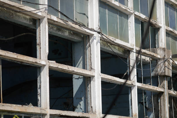 Broken walls and windows in an abandoned industrial building.