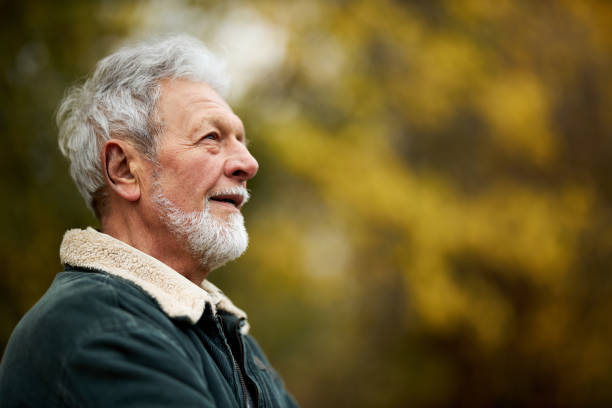 istock Mature man day dreaming in autumn day. 1422120721