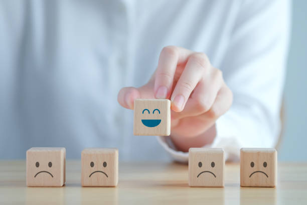istock Hand choosing happy face among unhappy faces on wooden blocks. Positive thinking, Feedback, Satisfaction, Customer service review, Mental health assessment, World mental health day concept. 1422121987