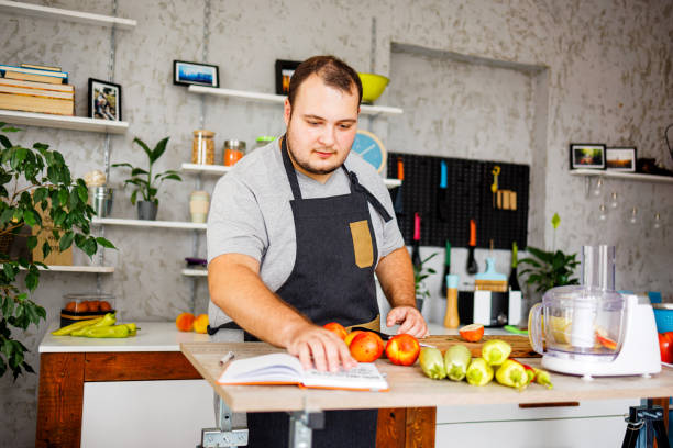 istock Overweight man reading healthy recipe 1422122368
