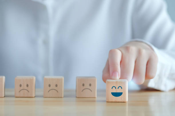 istock Hand choosing happy face among unhappy faces on wooden blocks. Positive thinking, Feedback, Satisfaction, Customer service review, Mental health assessment, World mental health day concept. 1422124905
