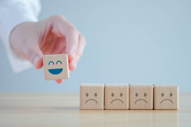 istock Hand choosing happy face among unhappy faces on wooden blocks. Positive thinking, Feedback, Satisfaction, Customer service review, Mental health assessment, World mental health day concept. 1422125945