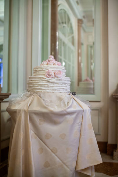 istock Multilevel wedding cake on the table decorated with roses 1422127256