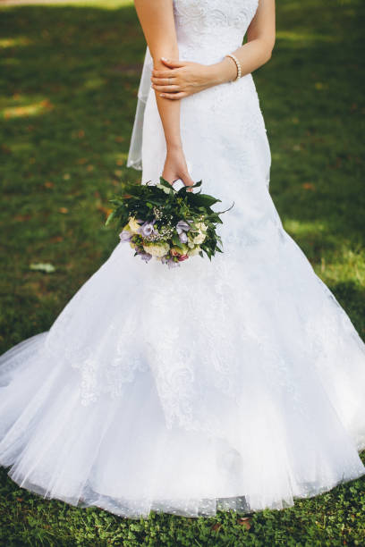 istock Bright wedding bouquet in hands of the bride 1422127509