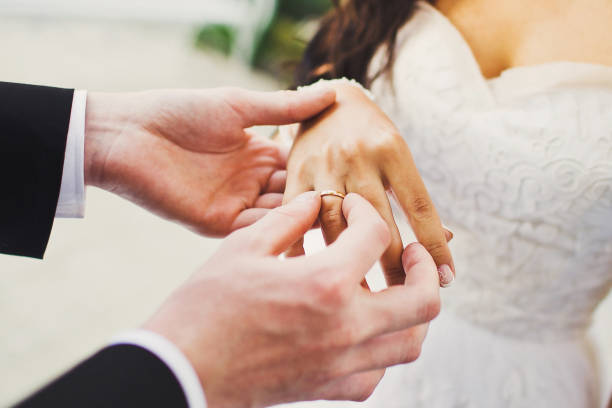 istock Bride and groom exchange rings at the wedding ceremony 1422127515