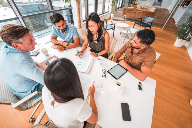 istock Mixed Race Business Consultants Working Together For A Corporate Client 1422128152