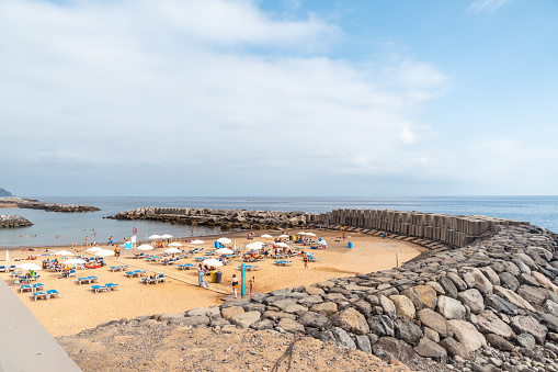 Praia da Calheta in summer, beach in summer with tourists, Madeira. Portugal