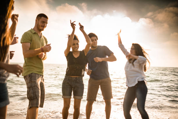 istock friends dancing at the beach party 1422134064
