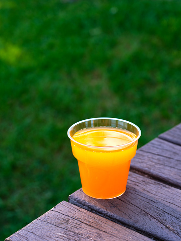 Healthy Carrot Juice (selective focus) on wooden background (close-up shot)