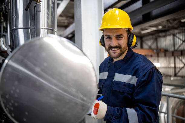portrait of heating plant worker standing by boiler and checking water temperature. - boiler power station fuel and power generation gas boiler imagens e fotografias de stock
