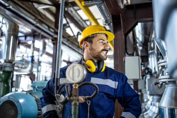 istock Blue collar worker in hardhat standing in power plant producing electricity. 1422138902