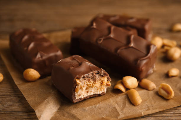 istock Chocolate bars with caramel, nuts and nougat on table, closeup 1422142259