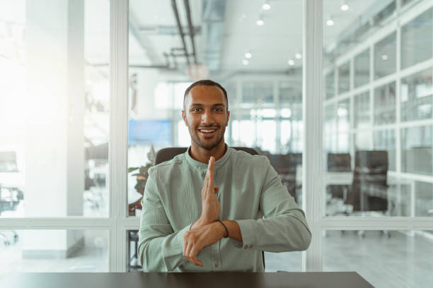 istock African businessman using sign language while talking online with client sitting in office 1422145871