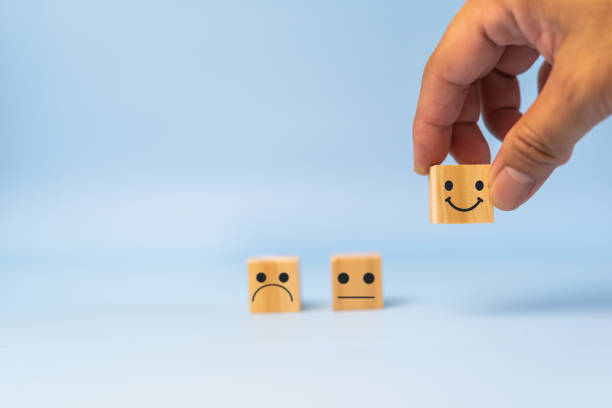 istock Customer service and Satisfaction concept happy Smiley face icon.Business feedback positive rating very impressed wood cube on table. 1422149141