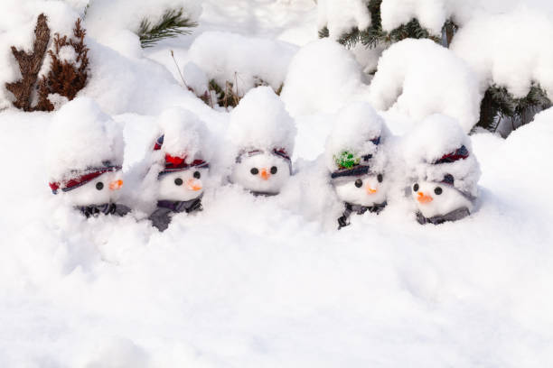 Five snowmen stick in a snow storm stock photo