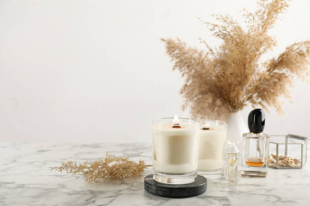 istock Composition with burning soy candles on white marble table, space for text 1422153561