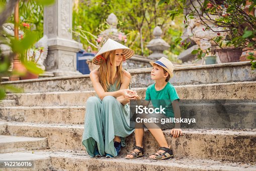 istock Mother and son tourists in Buddhist temple in Vietnam Nha Trang, Traveling with children concept 1422160116