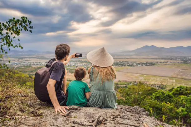 Photo of Happy tourists mom, dad and son travel to Vietnam. Travel to Asia concept. Traveling with kids concept