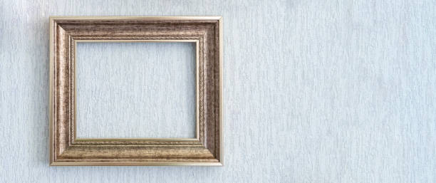 istock Baguette frame for brown picture or photograph hangs on light wall. 1422163437
