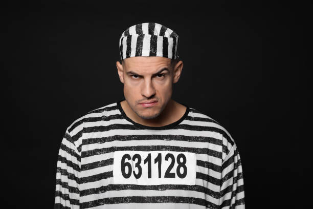 istock Prisoner in striped uniform on black background 1422163606