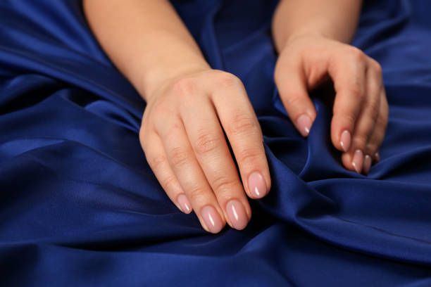 istock Woman touching silky blue fabric, closeup view 1422164949