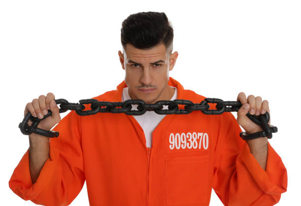 istock Prisoner in orange jumpsuit with chained hands on white background 1422165435