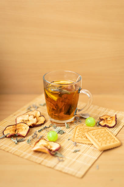 istock Cup of tea with mint, biscuits, candies and apple chips 1422178321