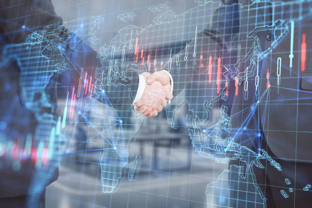 istock Close up and side view of businessmen shaking hands with creative forex grid map on blurry office interior background. Trade, teamwork, deal, finance, market and invest concept. Double exposure. 1422182548