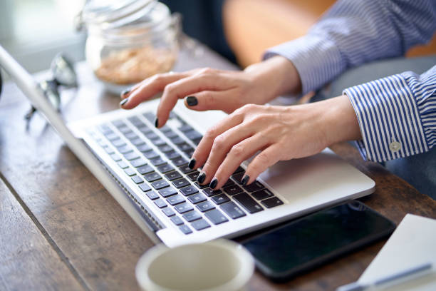istock hands and fingers of an asian woman working from home using notebook computer 1422183391