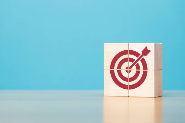 istock Wooden blocks with red target icon on wooden table blue background copy space. 1422185596