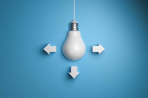 Light bulb with arrows on a blue background top view. 3d rendering. Creative idea concept.
