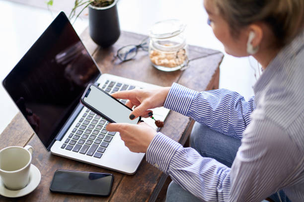 istock mature asian woman working from home using mobile phone and notebook computer 1422187565