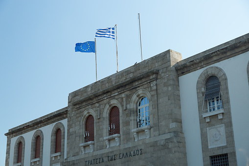 Bank of Greece Building in Rhodes with the EU and Greek flag