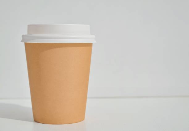 istock Mock-up of a paper coffee cup, isolated on a light gray background. 1422189373