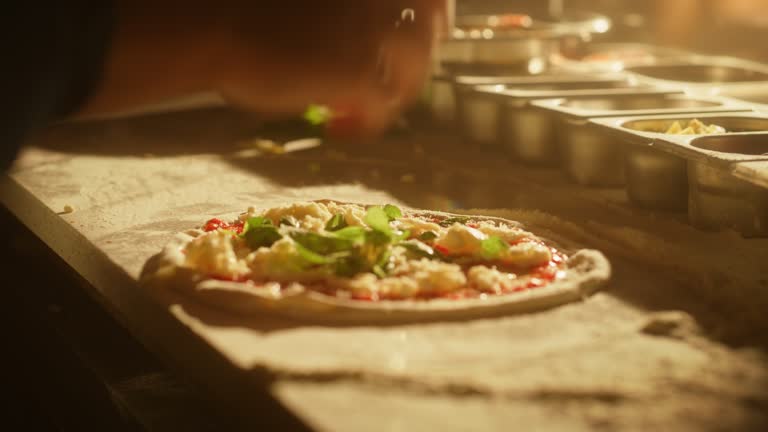 In Restaurant Professional Chef Preparing Pizza, Kneading Dough, Adding Ingredients, Special Sauce, Traditional Family Recipe. Authentic Italian Pizzeria with Delicious Organic Food. Focus on Hands