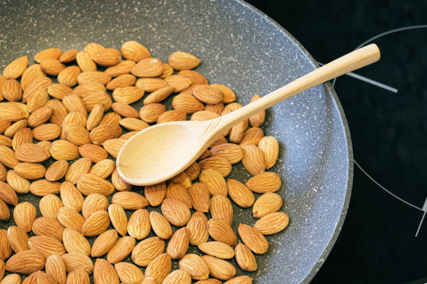 istock Roasting almond kernels in a frying pan 1422194938